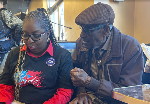 A photo featuring two members of The Ride urging people to get out and vote before Election Day.